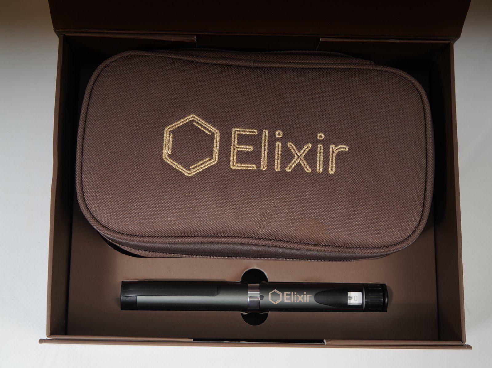 The Elixir case in its box — the embroidered Case with the pen