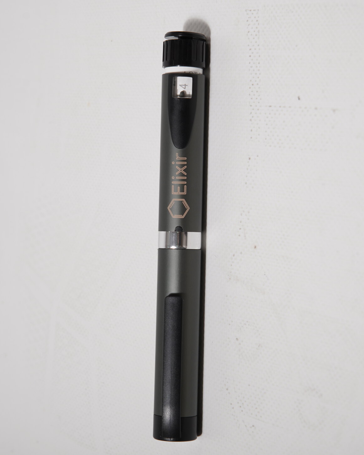 The Elixir Pen — matte finish with the gold hexagon mark