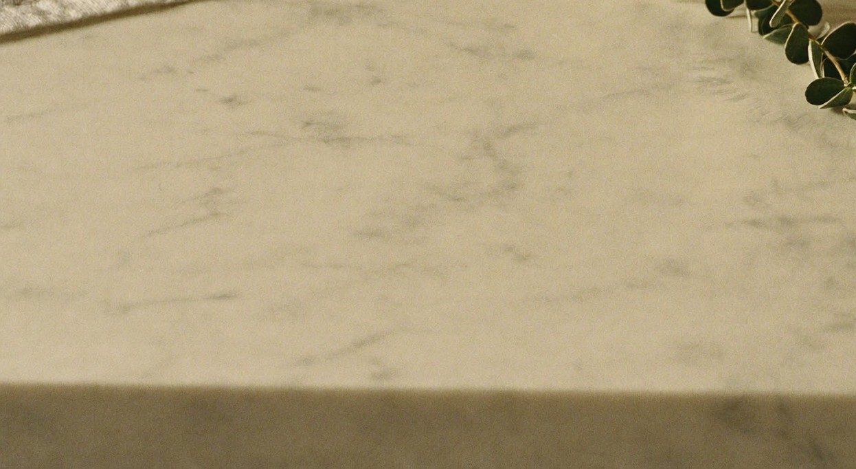 A marble surface with eucalyptus in soft morning light — the Elixir range